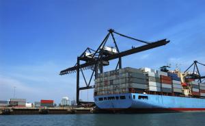 Freight Forwarders arranging a crane to move containers onto a ship as part of a mining and logistics project in Perth Australia